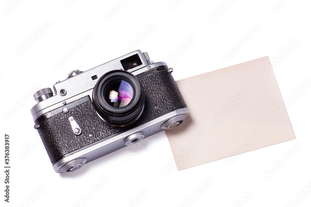 Mockup composition of old rangefinder film camera and photographic paper on white background.