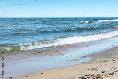 Seascape of the Lake Baikal. Waves with froth coming to the shore. Lifestyle.