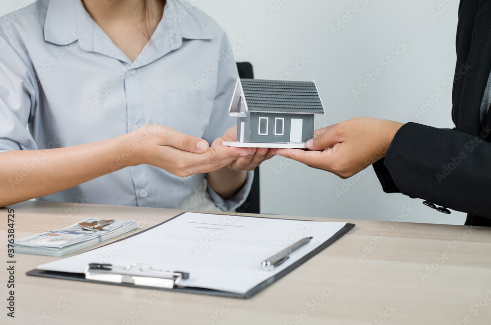 Real estate agent broker hand over the home to the new owner after completing the signing according to agreement renting a house and buy house insurance Home rental and insurance concept Real estate agent broker hand over the home to the new owner after completing the signing according to agreement renting a house and buy house insurance Home rental and insurance concept