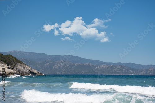 Coastline under a blue sky. Waves in front of the coast in Corsica. © Rodolphe