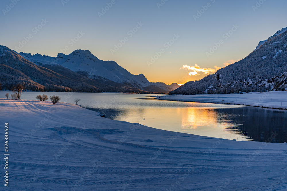 View of beautiful sunet at Lake Silvaplana, Switzerland, in cold winter evening