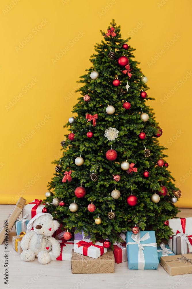 The interior of the room is a green Christmas tree with red gifts for the new year decor of the winter holiday home