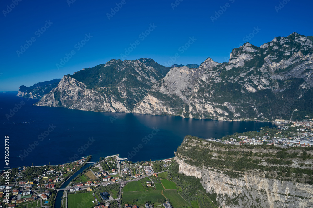 Perfect blue sky. Rock in the background the city of Riva del Garda, Italy. Alps Lake Garda and the city of Riva del Garda, Italy. Aerial view