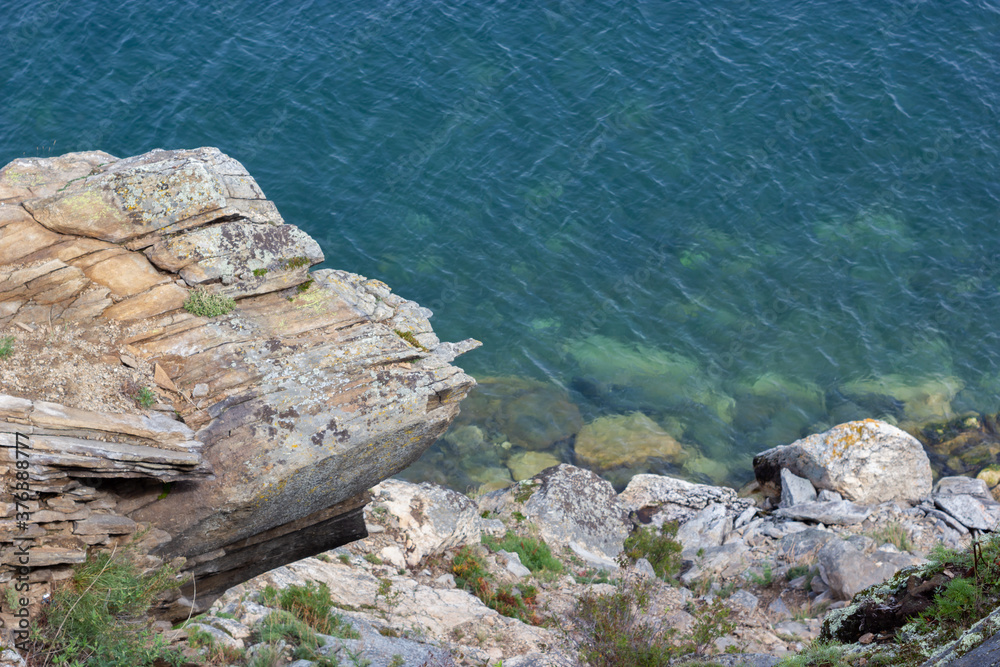 Top view of beautiful blue water from stone cliff Top view of beautiful blue water from stone cliff
