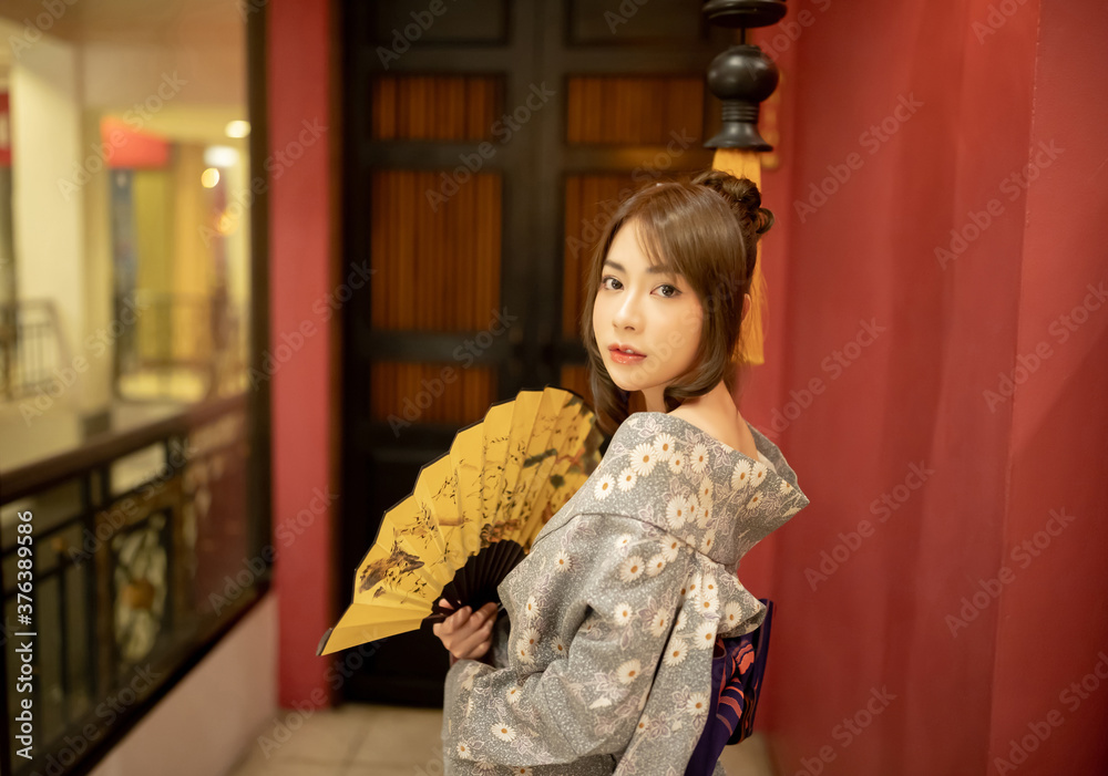 Young woman in traditional Japanese kimono and looking at camera, Japanese concept of kimono and yukata. Young woman in traditional Japanese kimono and looking at camera, Japanese concept of kimono and yukata.