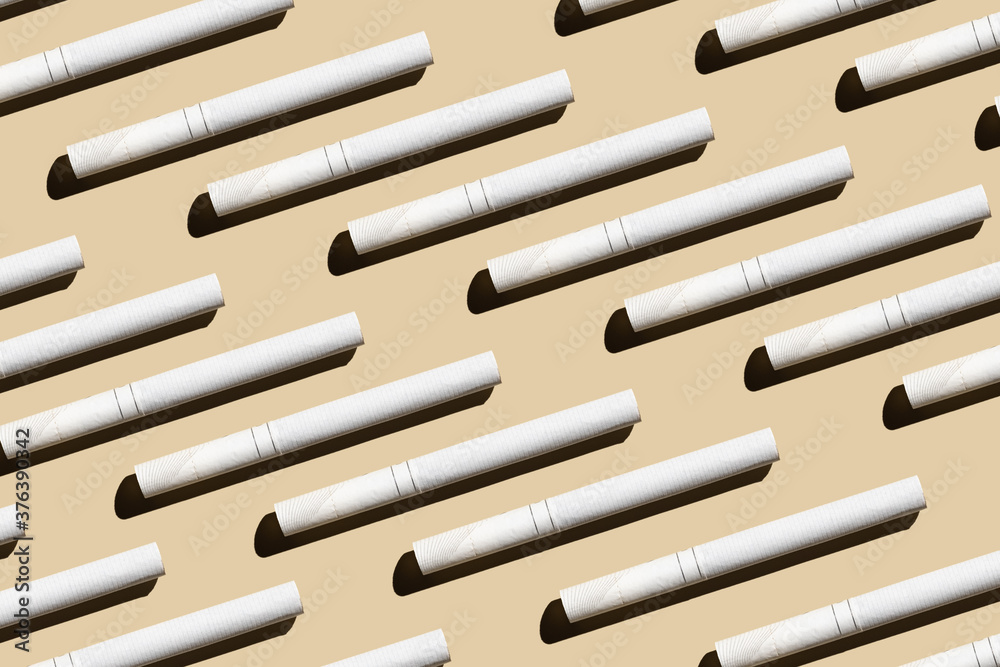 Pattern from cigarettes on a pastel beige background.Give up smoking cigarettes. Do not choose wrong lifestyle. Quit smoking addiction concept. Stop smoking message Pattern from cigarettes on a pastel beige background.Give up smoking cigarettes. Do not choose wrong lifestyle. Quit smoking addiction concept. Stop smoking message