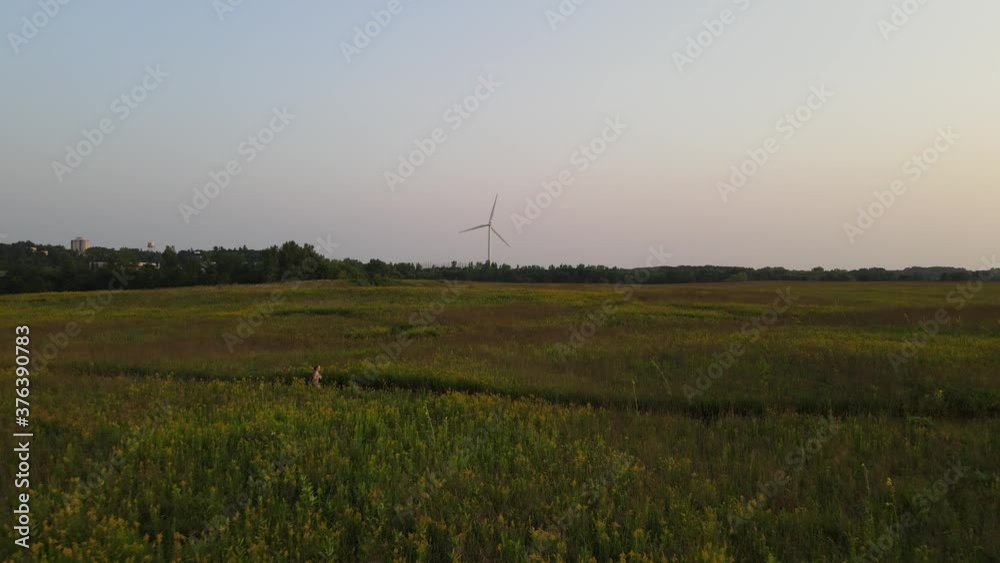 Windmill at the distance in the countryside at Minnesota Windmill at the distance in the countryside at Minnesota