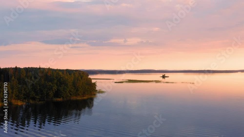 Drone shot of vast calm lake scenery by golden hour. photo