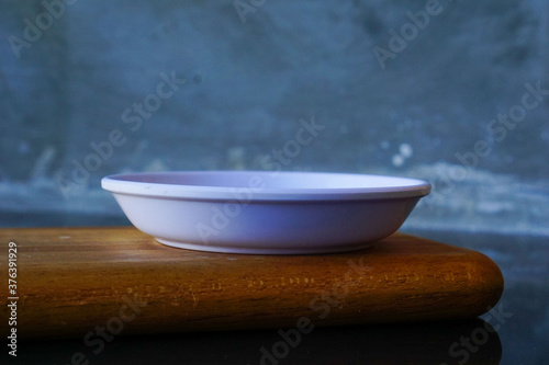 empty white plate on wooden board. kitchen life concept for cafe restaurant menu