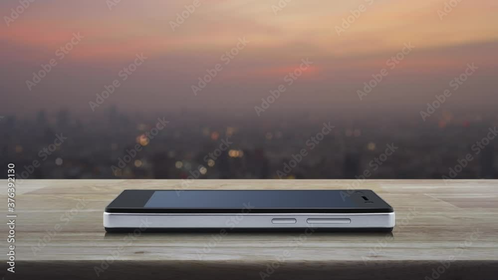 Gift box happy new year 2021 flat icon on modern smart mobile phone screen on wooden table over blur of cityscape on warm light sundown, Business happy new year 2021 shop online concept Gift box happy new year 2021 flat icon on modern smart mobile phone screen on wooden table over blur of cityscape on warm light sundown, Business happy new year 2021 shop online concept