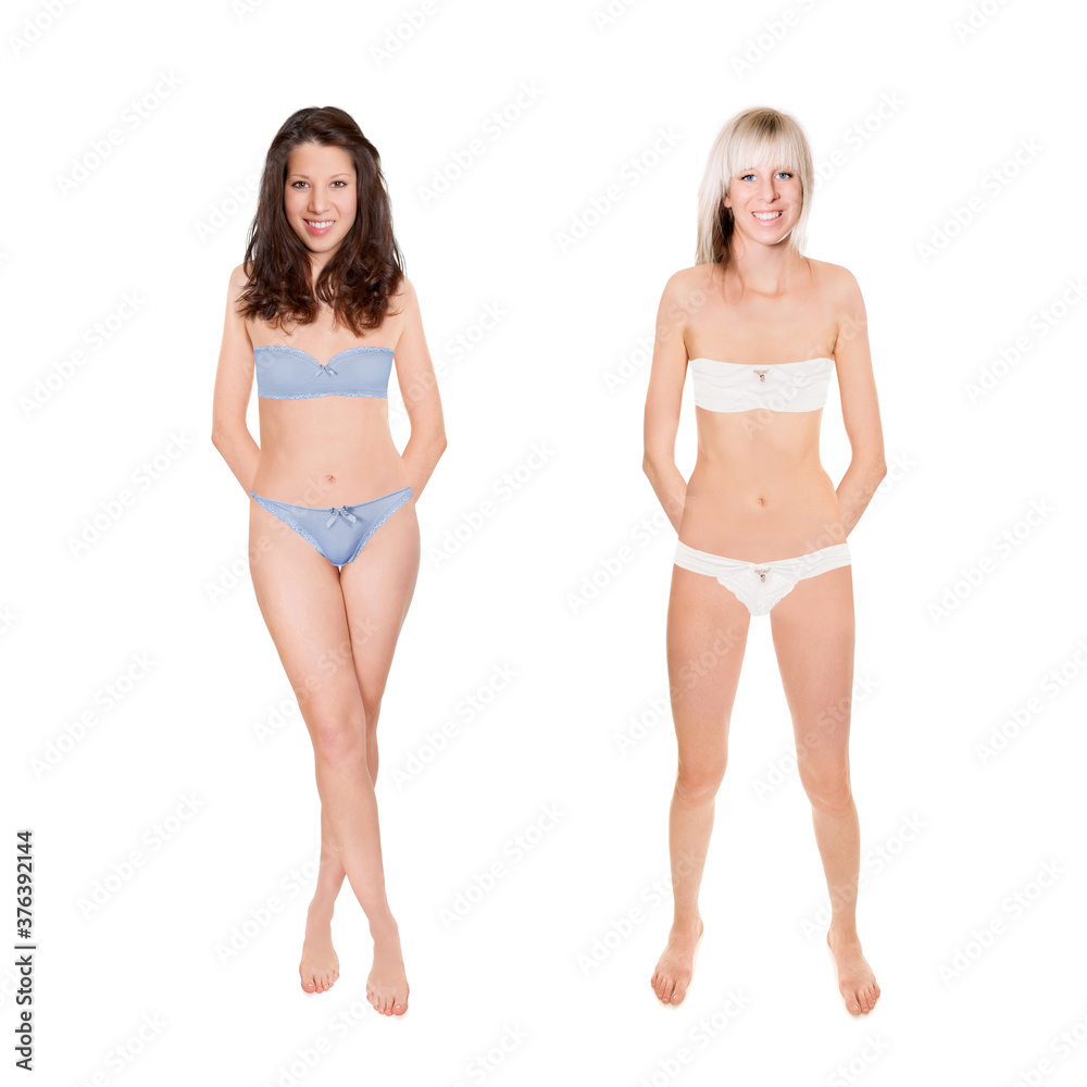 Two attractive young models wearing bra and panties, isolated in front of white studio background Two attractive young models wearing bra and panties, isolated in front of white studio background
