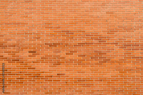 Brick wall of red stone blocks background