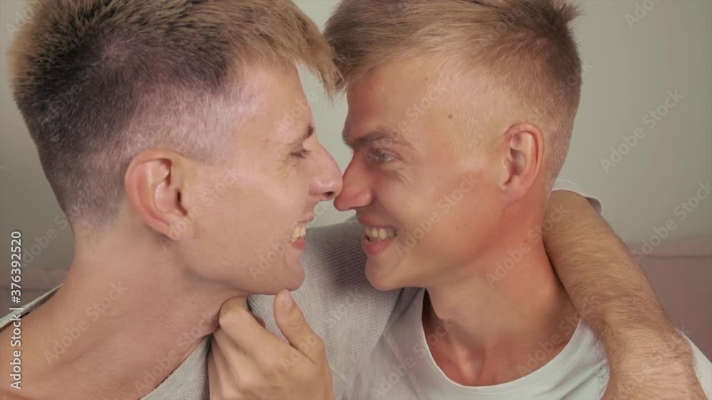 A couple of gay men, two handsome men chatting, sitting side by side and kissing. Kiss two guys. Spend time together. A couple of gay men, two handsome men chatting, sitting side by side and kissing. Kiss two guys. Spend time together.