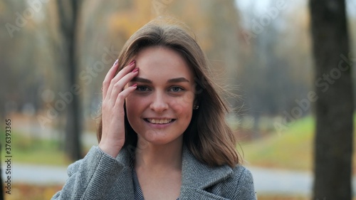 Portrait of a smiling young girl in an autumn park.