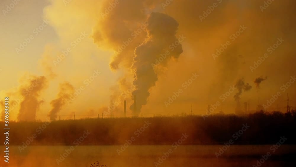 Chimneys at dawn. Epic pollution concept. A cloud of harmful substances. Metallurgical plant background Chimneys at dawn. Epic pollution concept. A cloud of harmful substances. Metallurgical plant background