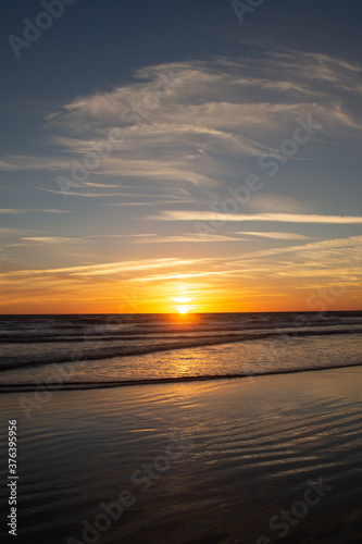 Sunset in the long beach of Zahara de los Atunes marking the horizon line in the Atlantic Ocean, Cadiz, Spain © Gloria