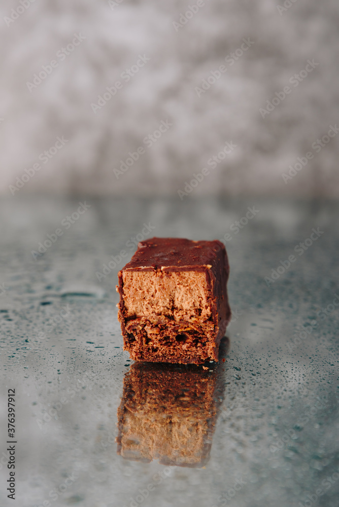 Chocolate cake cut on a mirror surface Chocolate cake cut on a mirror surface