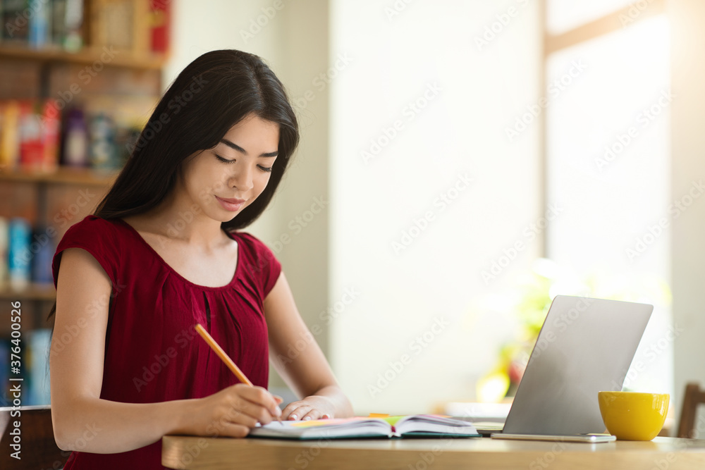 Beautiful Asian Student Girl Studying With Laptop In Cafe And Taking Notes Beautiful Asian Student Girl Studying With Laptop In Cafe And Taking Notes