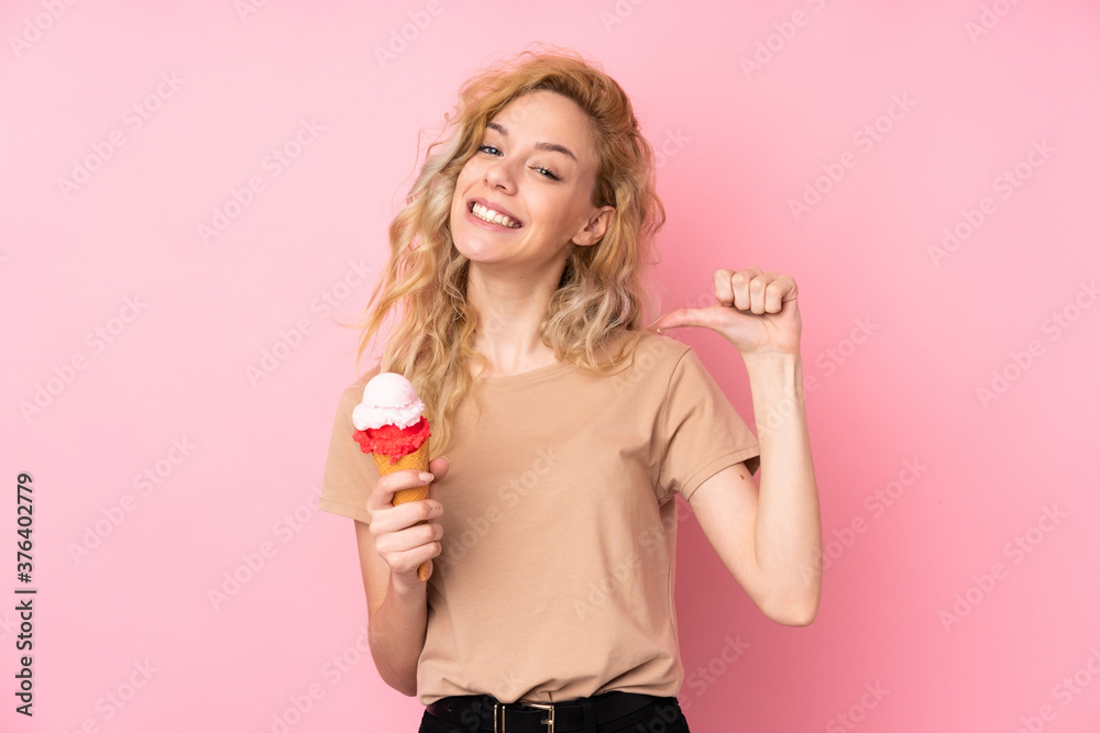 Young blonde woman holding a cornet ice cream isolated on pink background proud and self-satisfied Young blonde woman holding a cornet ice cream isolated on pink background proud and self-satisfied
