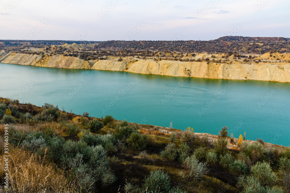 Lake with sandy bank in the abandoned coal quarry
