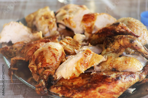 Rotisserie Chicken. Charcoal grilled chicken on the grill. Roast chicken on a divider. Served chicken.