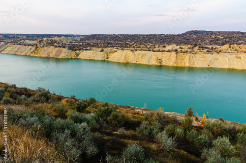 Lake with sandy bank in the abandoned coal quarry © ihorbondarenko
