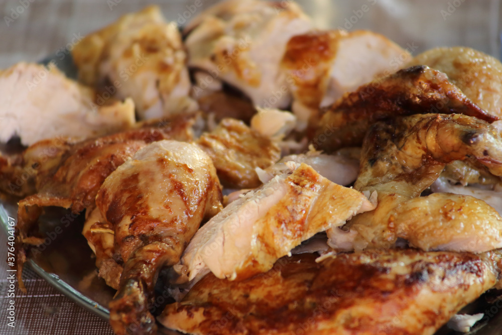 Rotisserie Chicken. Charcoal grilled chicken on the grill. Roast chicken on a divider. Served chicken.