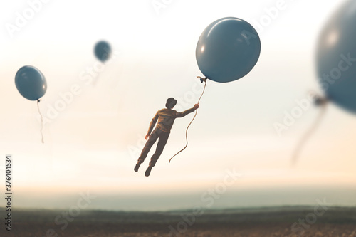 surreal moment, man flying away with a big balloon