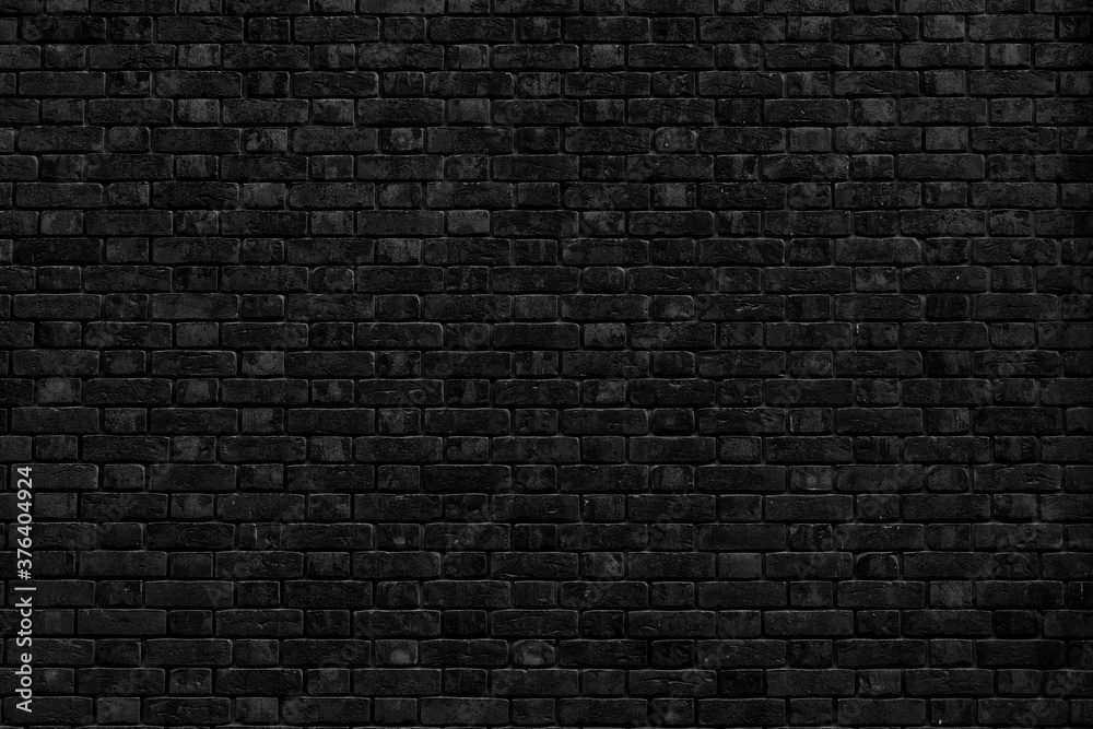 Black brick building wall. Interior of a modern loft. Background for design Black brick building wall. Interior of a modern loft. Background for design