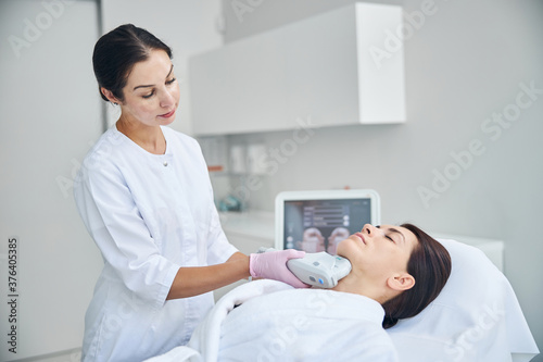 Obraz na plátně Attractive lady lying still during the ultrasound therapy