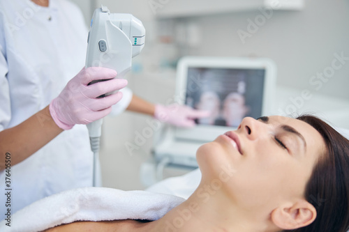 Doctor adjusting the treatment settings for her patient