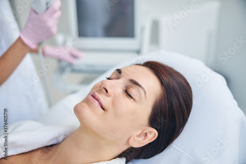 Serene pleased patient daydreaming before a procedure