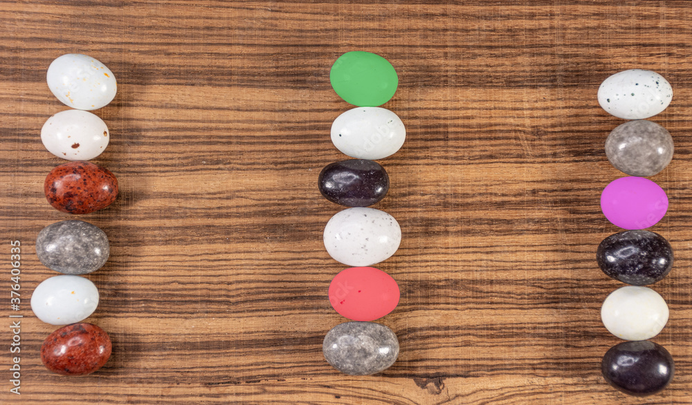 Colorful chocolate eggs on exotic natural wood background Colorful chocolate eggs on exotic natural wood background