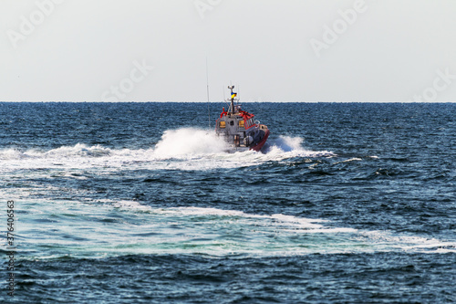 A rescue boat in the sea monitors the safety of tourists on the water and stops violators of order and safe rest. Sea boat coastal beach rescue patrol service