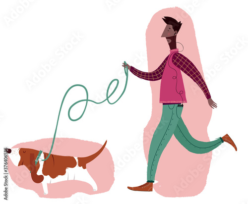 A man walking a basset hound dog with a pink background