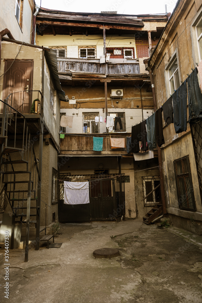 A colorful landscape of ruined houses in a poor neighborhood for poor people. Construction of a poor state. , Architecture of the poor neighborhood. An old house in the area of smells A colorful landscape of ruined houses in a poor neighborhood for poor people. Construction of a poor state. , Architecture of the poor neighborhood. An old house in the area of smells