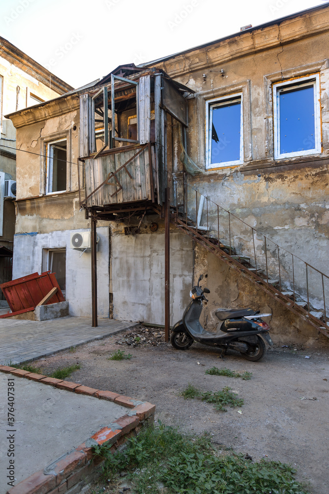 A colorful landscape of ruined houses in a poor neighborhood for poor people. Construction of a poor state. , Architecture of the poor neighborhood. An old house in the area of smells