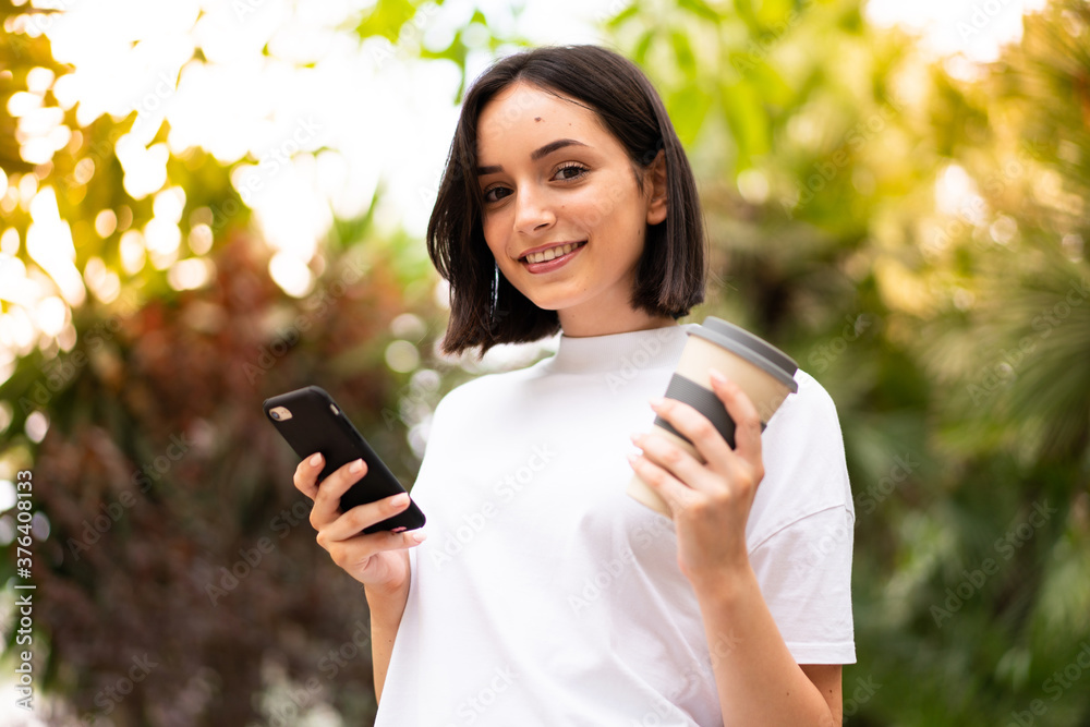 Young caucasian woman using a phone at outdoors Young caucasian woman using a phone at outdoors