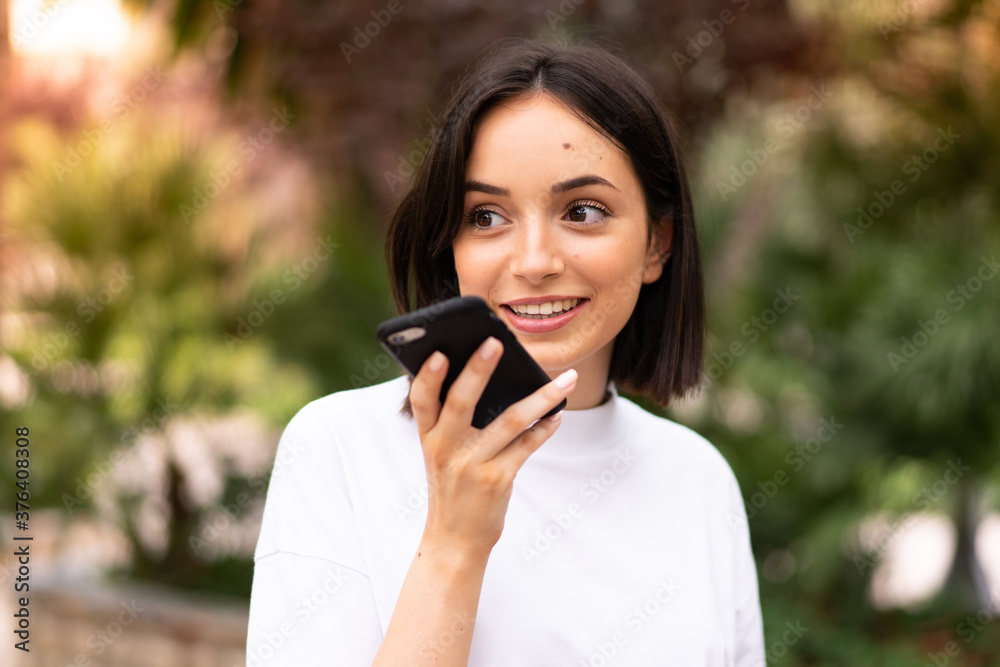 Young caucasian woman using a phone at outdoors Young caucasian woman using a phone at outdoors