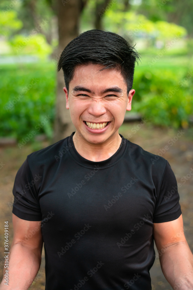 asian guy training his body in the park