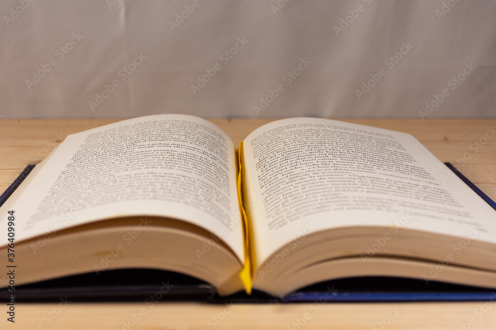 Open book on a natural wooden background Open book on a natural wooden background