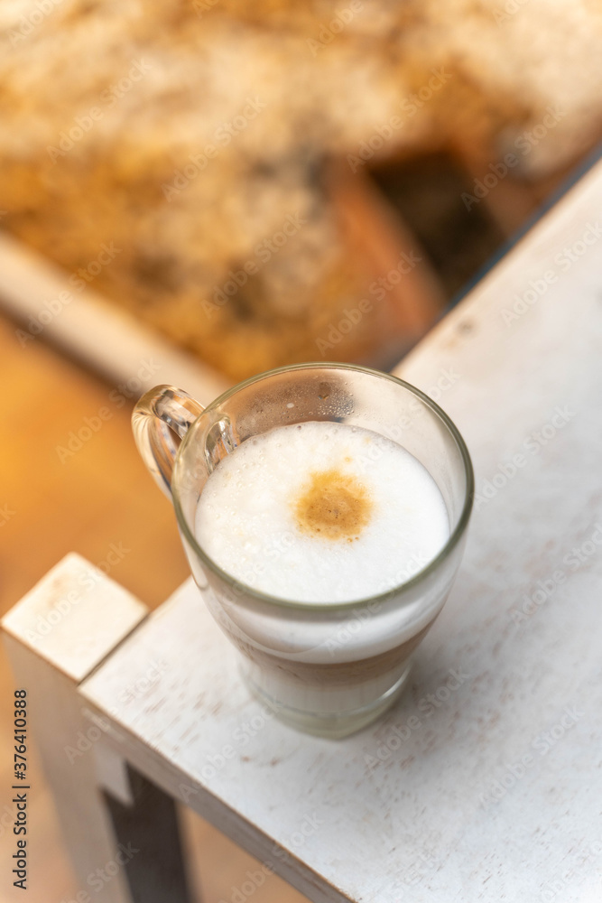 a cup of coffee on wooden table with work break time, food concept. Close up of a glass of hot Coffee Latte with nice milk form with copy space a cup of coffee on wooden table with work break time, food concept. Close up of a glass of hot Coffee Latte with nice milk form with copy space