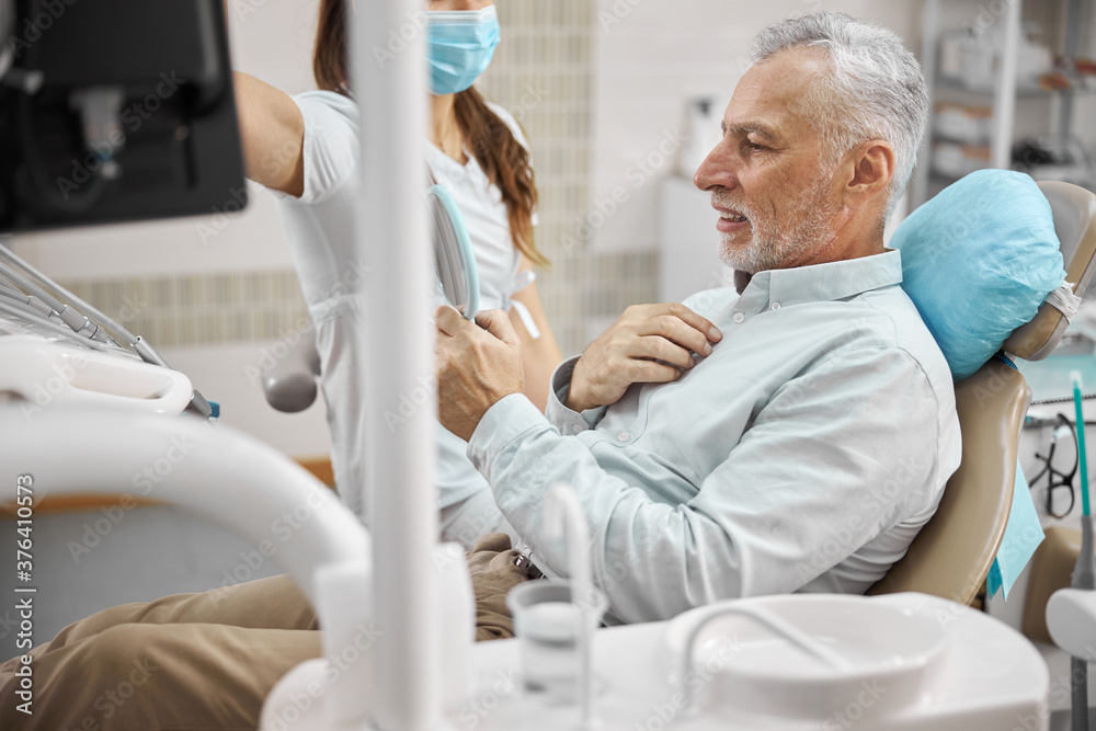 Aging man having an appointment with a dentist Aging man having an appointment with a dentist
