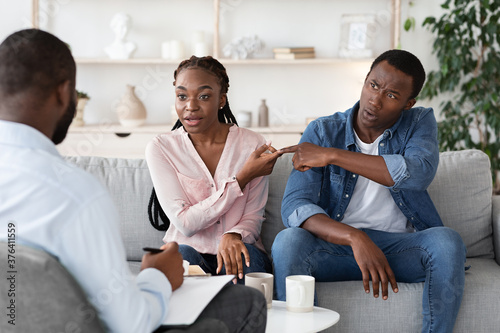 Young Black Couple Blaming Each Other In Relationship Problems At Counselor's Office © Prostock-studio