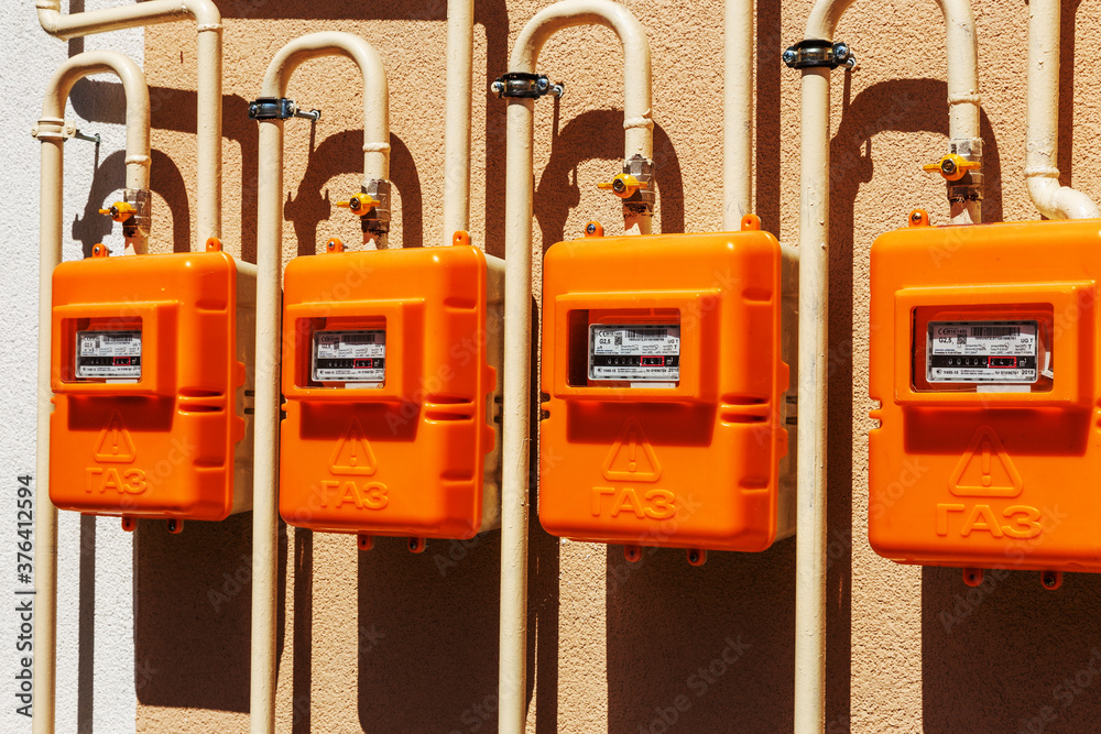 ODESSA, UKRAINE - August 15, 2018: Number of new meters of natural gas on outer wall of residential building. New meters for measuring natural gas consumption in households. Inscription: ODESSA, UKRAINE - August 15, 2018: Number of new meters of natural gas on outer wall of residential building. New meters for measuring natural gas consumption in households. Inscription: