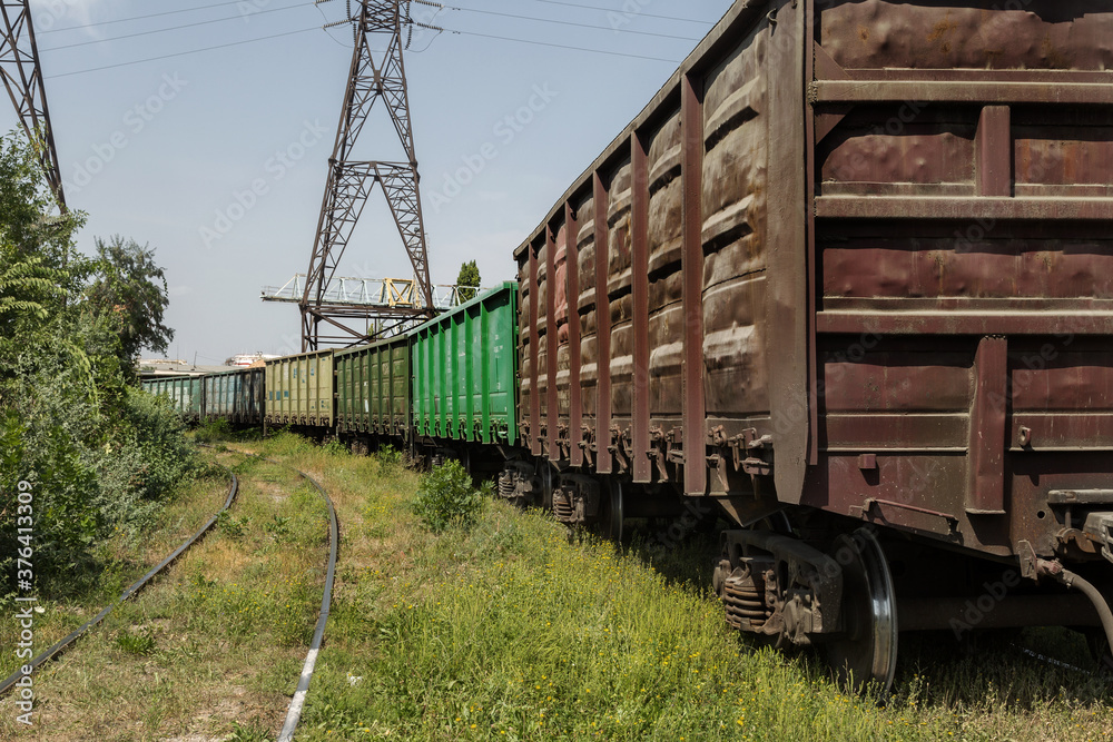 Railway station with freight cars in industrial depot of the power plant. Colorful industrial landscape. Railway in depot. The railway platform. Heavy industry. Cargo transportation by railroad cars Railway station with freight cars in industrial depot of the power plant. Colorful industrial landscape. Railway in depot. The railway platform. Heavy industry. Cargo transportation by railroad cars