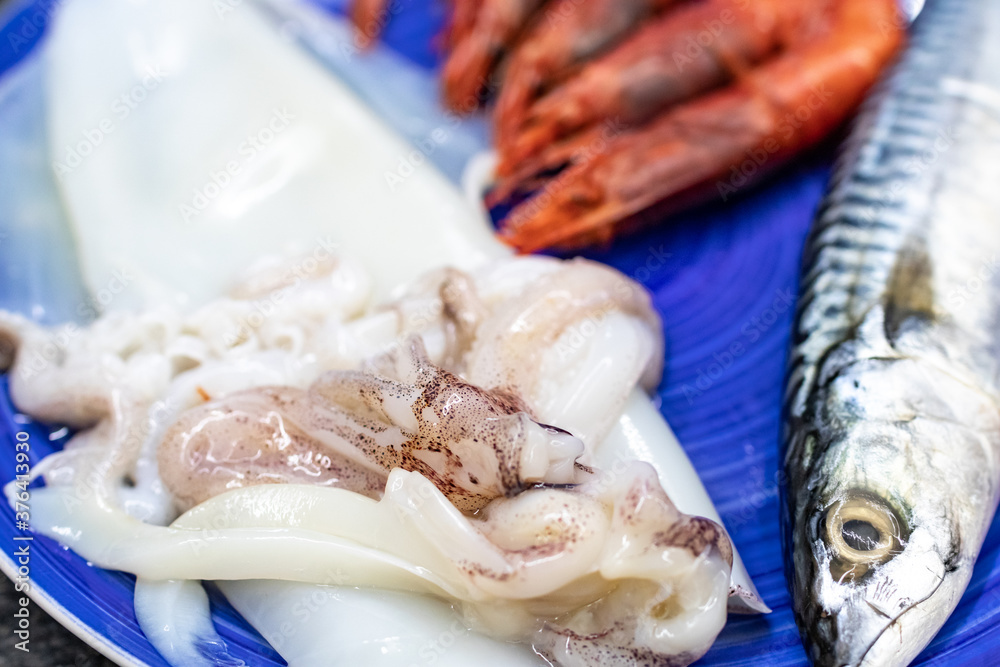mackerel, red prawns and squid. Raw fish rich in omega 3 ready to be