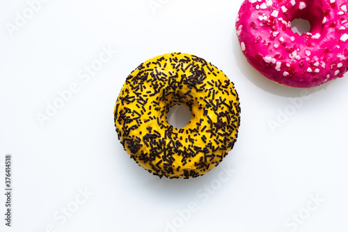 pink and yellow doughnut with sprinkles isolated