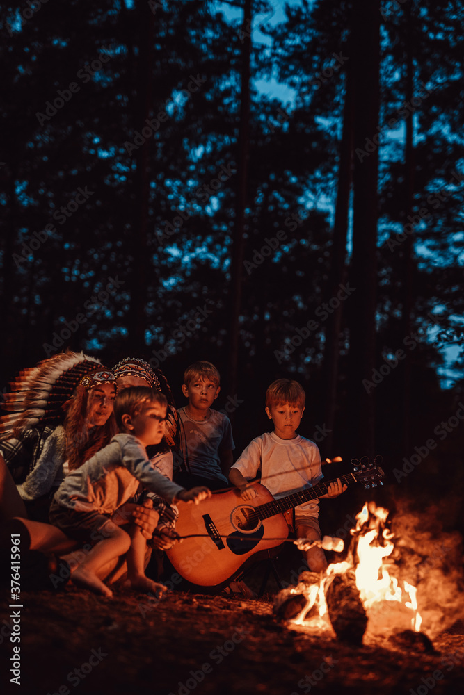 Family of three boys mother and father have a good time and resting in forest on weekend on holidays. Family of three boys mother and father have a good time and resting in forest on weekend on holidays.