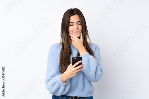 Young teenager Brazilian girl over white background